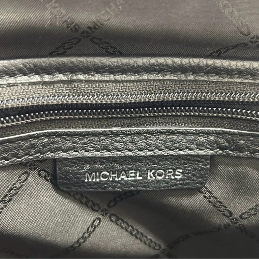 Michael Kors Rhea Medium Backpack in black pebbled leather  silver-tone dust bag